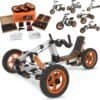 Electric go-kart with orange wheels and adjustable seat, includes tools and accessories for assembly.
