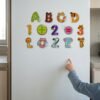 Animal Alphabet Magnets: a child placing a piece Animal Alphabet Magnets: a child placing a piece