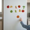 Fruit & Vegetable Magnets: a child placing a piece Fruit & Vegetable Magnets: a child placing a piece