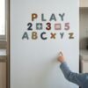Magnetic Letters & Numbers: a child placing a piece Magnetic Letters & Numbers: a child placing a piece