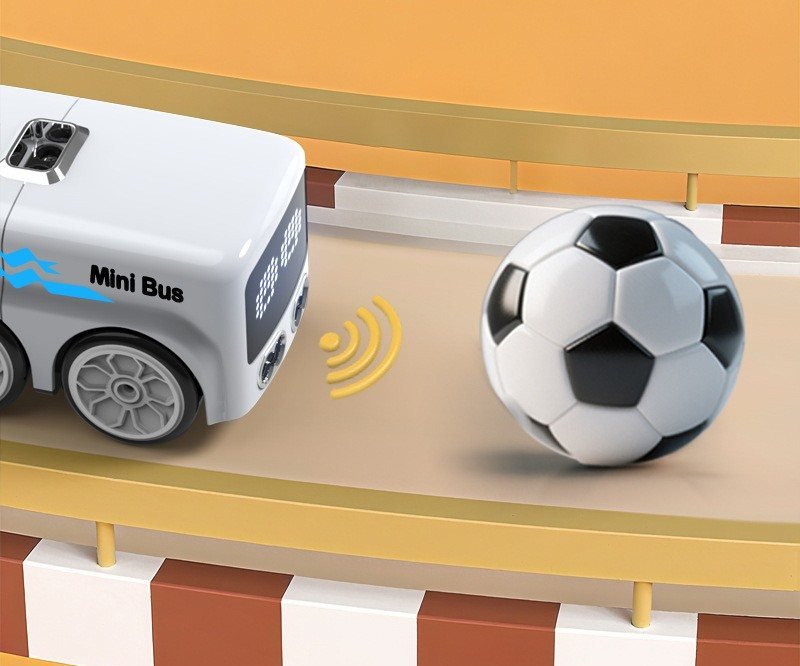 Mini bus following a football along a toy road