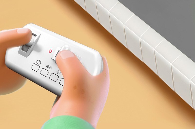 Hand holding the mini bus remote control