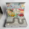 The open box with a pop-up town scene in the lid and a printed road mat